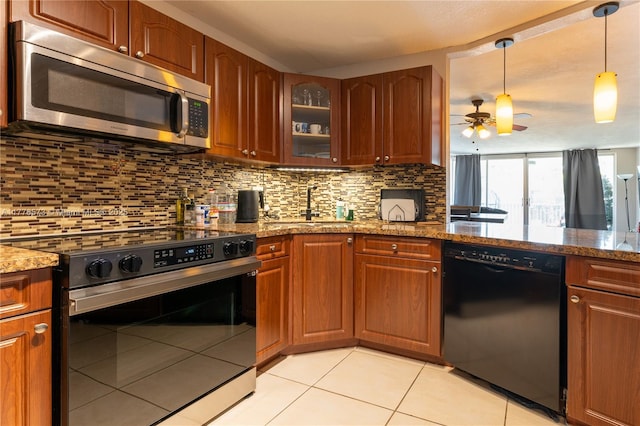 1680 NE 191st St Unit 307-2, Miami, FL 33179 - kitchen featuring stainless steel appliances, a sink, stone counters, ceiling fan, and light tile patterned floors
