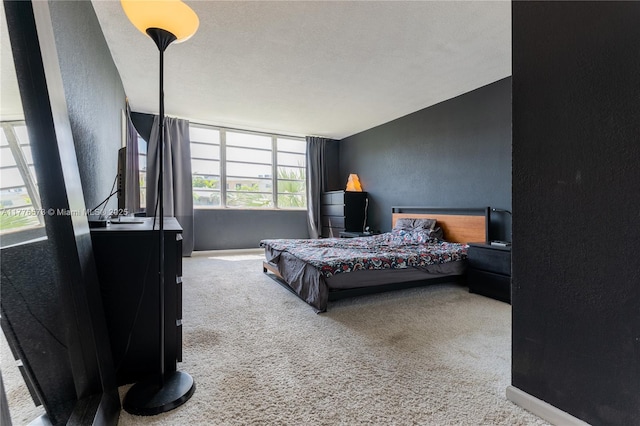 1680 NE 191st St Unit 307-2, Miami, FL 33179 - carpeted bedroom featuring a textured wall and baseboards