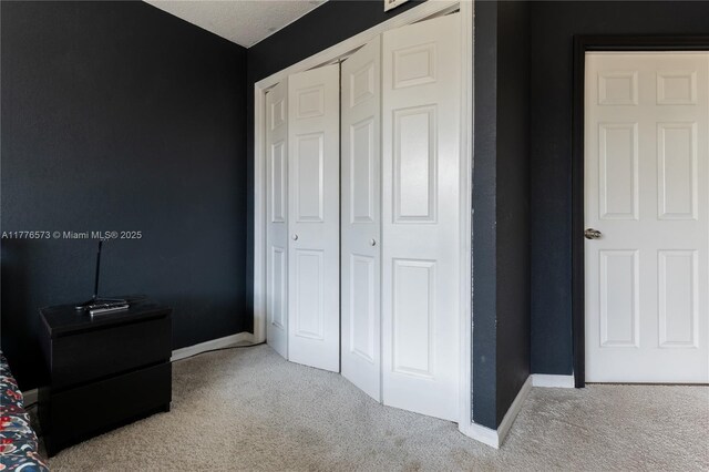 1680 NE 191st St Unit 307-2, Miami, FL 33179 - bedroom with carpet, a closet, and baseboards