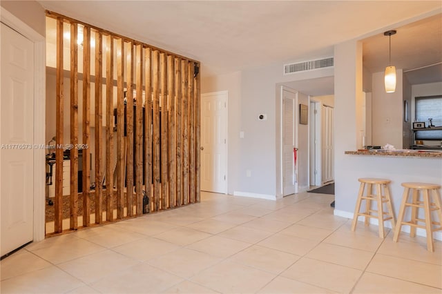 1680 NE 191st St Unit 307-2, Miami, FL 33179 - unfurnished living room with tile patterned floors and baseboards