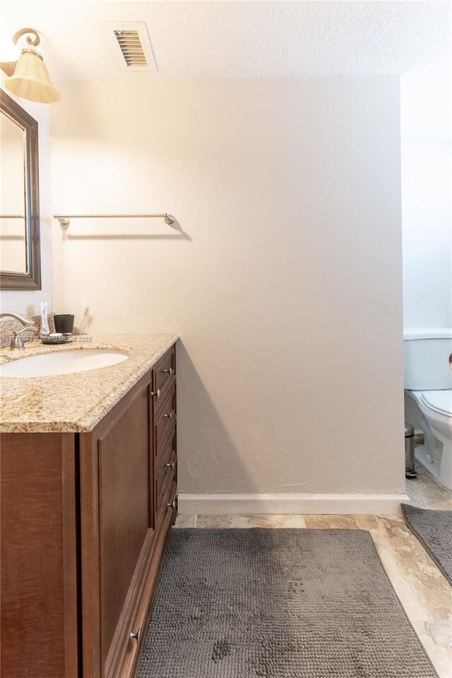 1680 NE 191st St Unit 307-2, Miami, FL 33179 - bathroom with toilet, vanity, and baseboards
