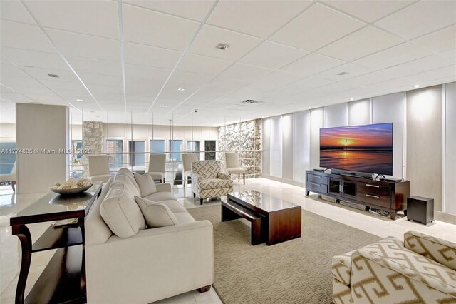 3111 N Ocean Dr Unit 308, Hollywood, FL 33019 - tiled living room with expansive windows, a drop ceiling, and carpet