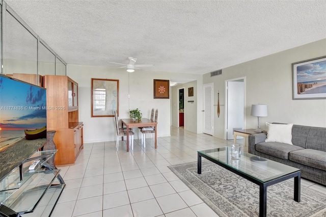 3111 N Ocean Dr Unit 308, Hollywood, FL 33019 - living room with light tile patterned floors, a textured ceiling, visible vents, and a ceiling fan