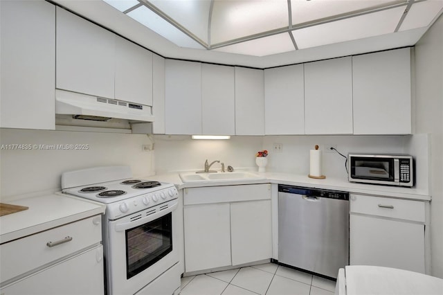 3111 N Ocean Dr Unit 308, Hollywood, FL 33019 - kitchen with light countertops, stainless steel appliances, under cabinet range hood, a sink, and white cabinets