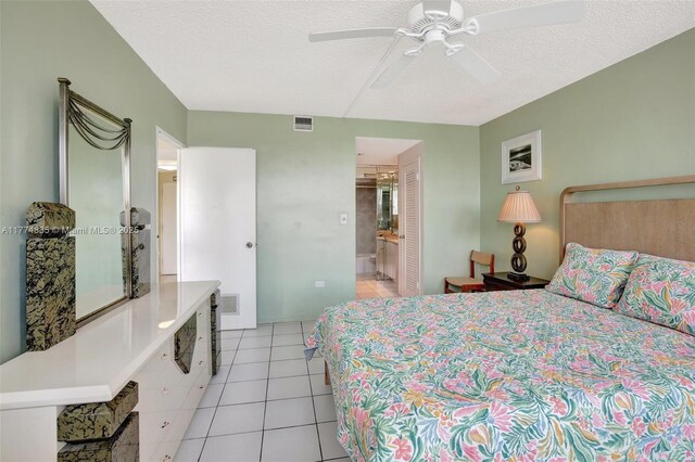 3111 N Ocean Dr Unit 308, Hollywood, FL 33019 - bedroom with light tile patterned flooring, a textured ceiling, ensuite bath, and visible vents