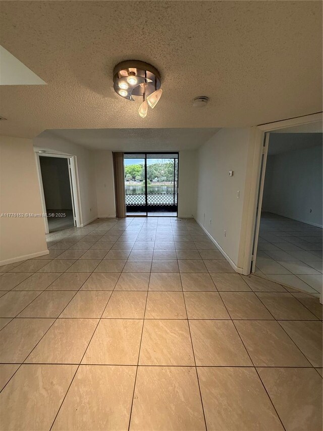 8335 SW 152nd Ave Unit B-106, Miami, FL 33193 - unfurnished room featuring light tile patterned floors and a textured ceiling