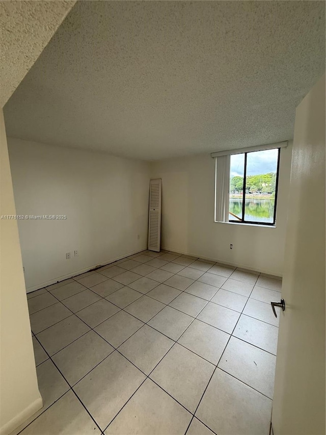 8335 SW 152nd Ave Unit B-106, Miami, FL 33193 - spare room featuring a textured ceiling and light tile patterned flooring
