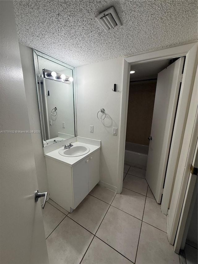 8335 SW 152nd Ave Unit B-106, Miami, FL 33193 - bathroom featuring vanity, a textured ceiling, and tile patterned flooring