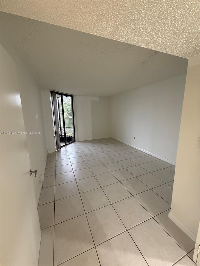 8335 SW 152nd Ave Unit B-106, Miami, FL 33193 - unfurnished room with a textured ceiling, light tile patterned floors, and expansive windows