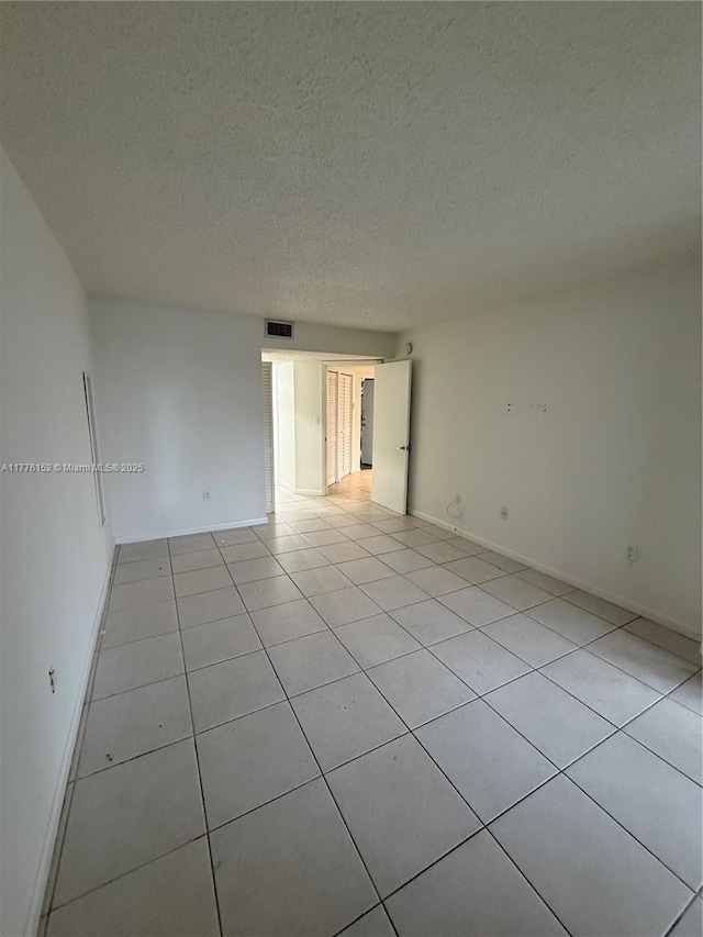 8335 SW 152nd Ave Unit B-106, Miami, FL 33193 - spare room with light tile patterned floors and a textured ceiling