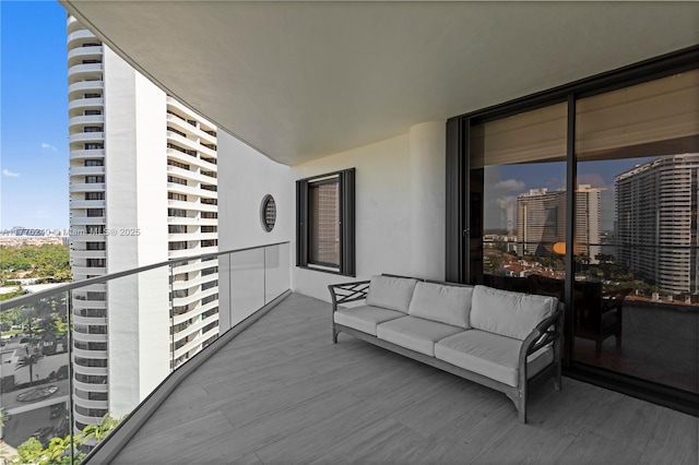 balcony with an outdoor living space and a view of city