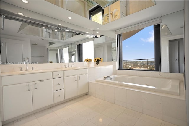 bathroom featuring a sink, a jetted tub, and a healthy amount of sunlight
