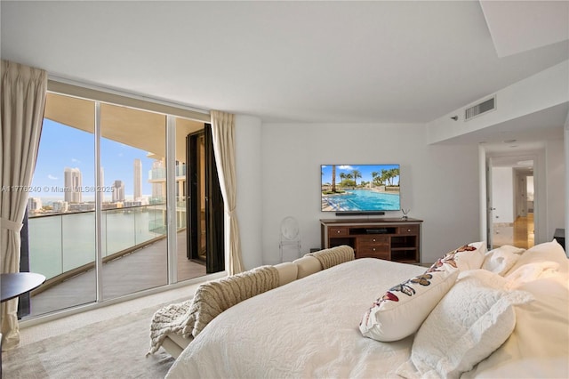 bedroom featuring access to exterior, visible vents, carpet floors, and floor to ceiling windows