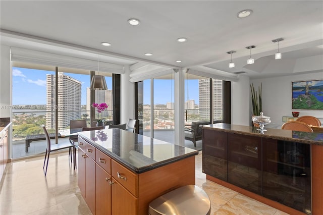 kitchen with recessed lighting, dark stone counters, and a center island