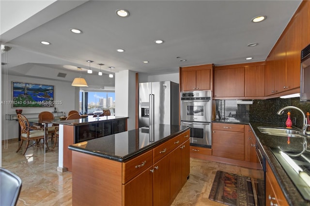 kitchen with a sink, a kitchen island, stainless steel appliances, marble finish floor, and decorative backsplash