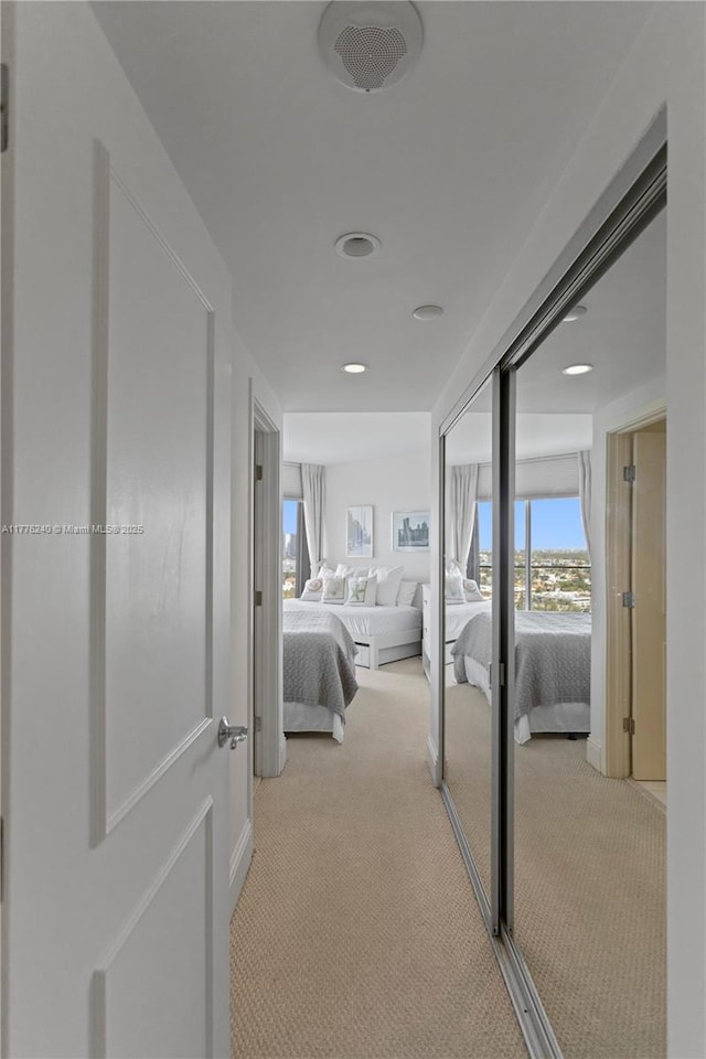 hall featuring visible vents and carpet