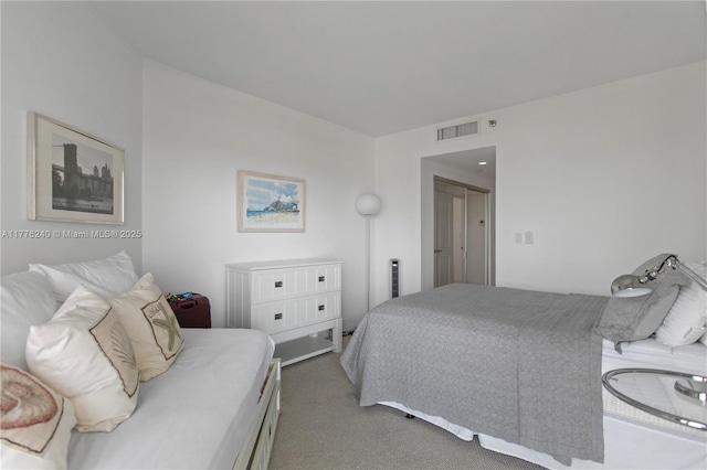 bedroom with visible vents and carpet