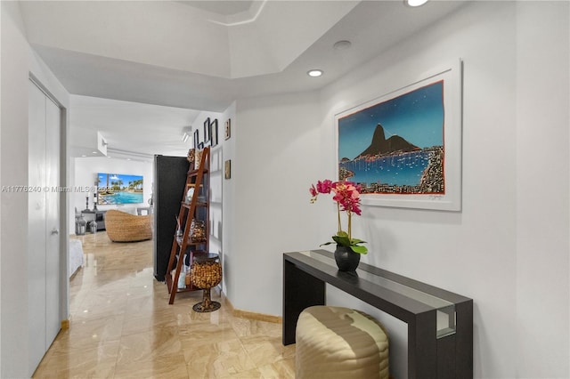 hall featuring baseboards, marble finish floor, and recessed lighting