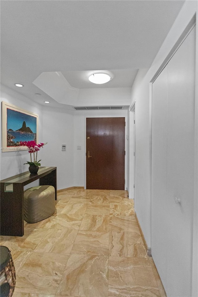 hallway with marble finish floor