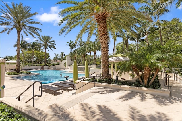 pool with fence and a patio area