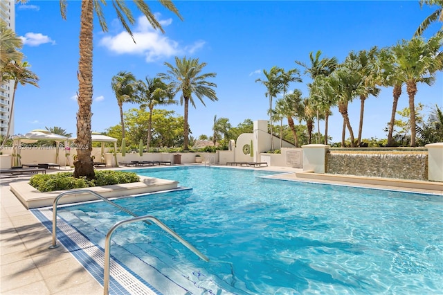 community pool featuring fence and a patio