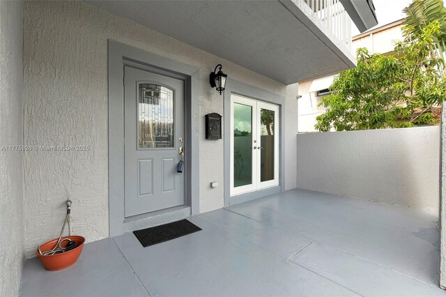 doorway to property with stucco siding and french doors