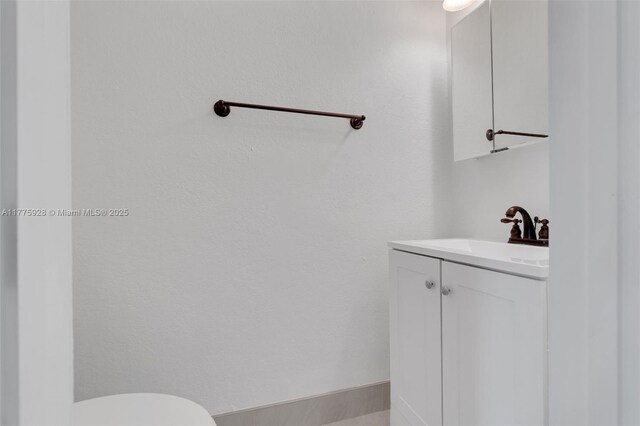 bathroom featuring vanity and toilet