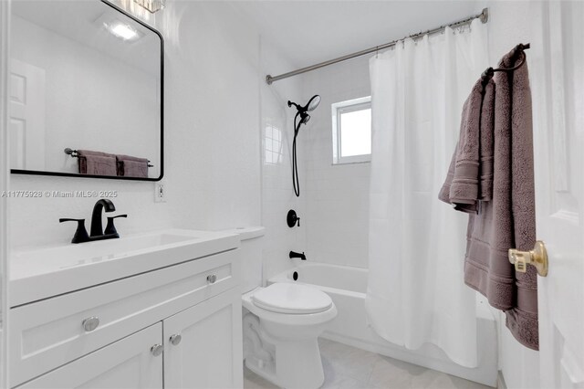 bathroom with vanity, shower / bath combo, and toilet