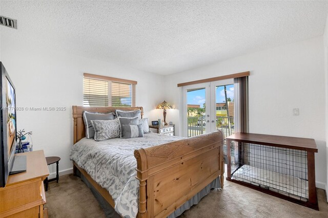 carpeted bedroom with french doors, a textured ceiling, visible vents, baseboards, and access to outside