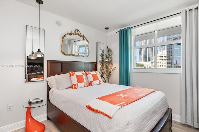 1250 S Miami Ave Unit 1206, Miami, FL 33130 - bedroom featuring baseboards and light wood-type flooring