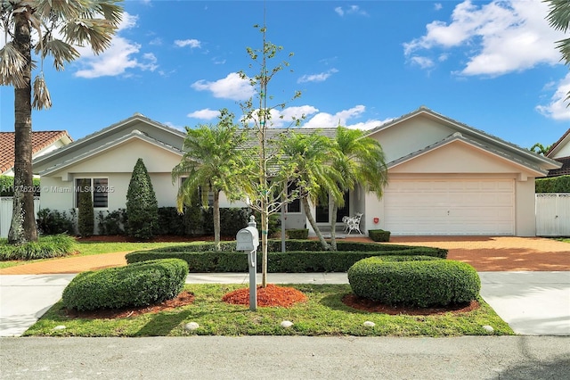 11472 SW 28th Ter, Miami, FL 33165 - single story home with decorative driveway, stucco siding, an attached garage, and fence