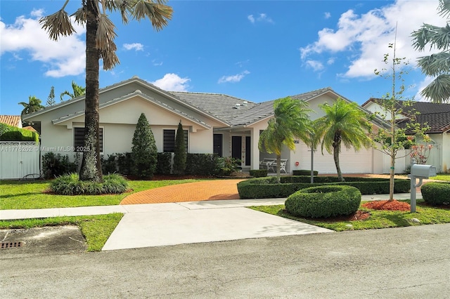 11472 SW 28th Ter, Miami, FL 33165 - ranch-style house featuring stucco siding, decorative driveway, and fence
