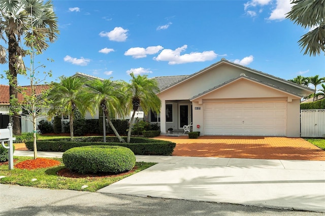 11472 SW 28th Ter, Miami, FL 33165 - single story home with decorative driveway, stucco siding, a garage, fence, and a tile roof