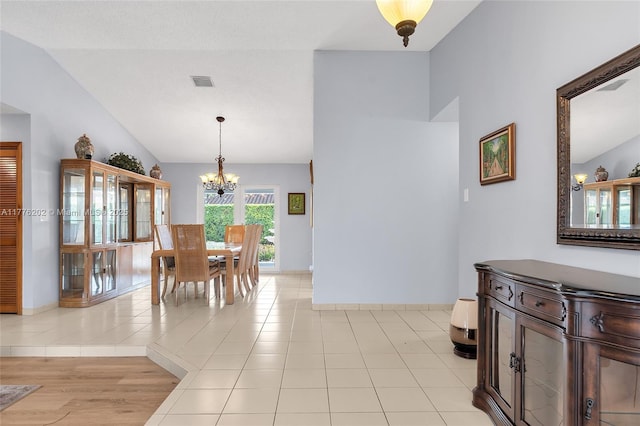 11472 SW 28th Ter, Miami, FL 33165 - dining space with a chandelier, lofted ceiling, baseboards, and light tile patterned floors