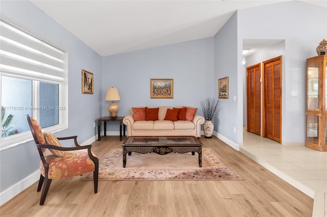 11472 SW 28th Ter, Miami, FL 33165 - living area featuring wood finished floors, baseboards, and lofted ceiling