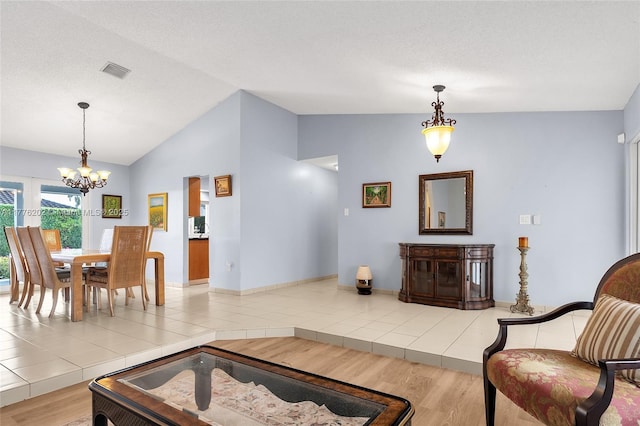 11472 SW 28th Ter, Miami, FL 33165 - living area with a chandelier, vaulted ceiling, wood finished floors, a fireplace, and baseboards