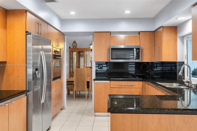 11472 SW 28th Ter, Miami, FL 33165 - kitchen featuring appliances with stainless steel finishes, light tile patterned floors, dark stone countertops, tasteful backsplash, and recessed lighting