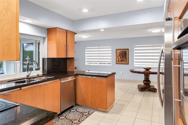 11472 SW 28th Ter, Miami, FL 33165 - kitchen with stainless steel dishwasher, a sink, a peninsula, dark stone counters, and black electric cooktop