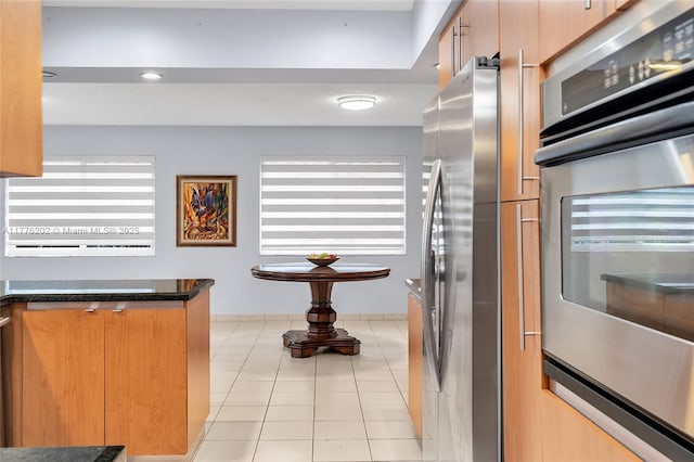 11472 SW 28th Ter, Miami, FL 33165 - kitchen featuring appliances with stainless steel finishes, healthy amount of natural light, light tile patterned floors, and brown cabinetry