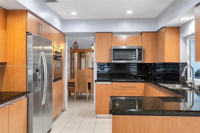 11472 SW 28th Ter, Miami, FL 33165 - kitchen featuring stainless steel appliances, light tile patterned flooring, a sink, dark stone countertops, and tasteful backsplash