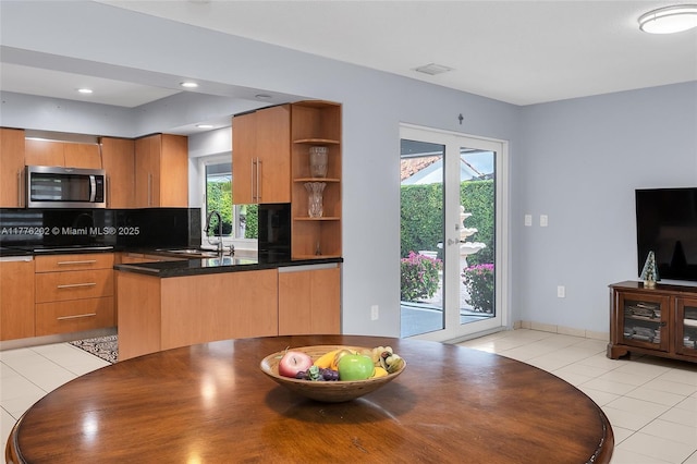 11472 SW 28th Ter, Miami, FL 33165 - kitchen featuring stainless steel microwave, a sink, open shelves, tasteful backsplash, and light tile patterned floors