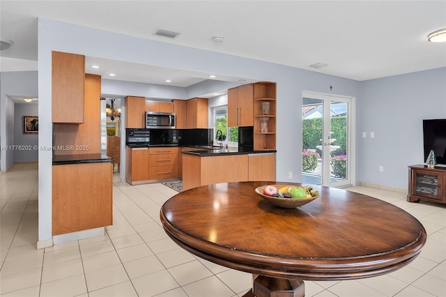 11472 SW 28th Ter, Miami, FL 33165 - kitchen featuring stainless steel microwave, open shelves, dark countertops, a sink, and a peninsula