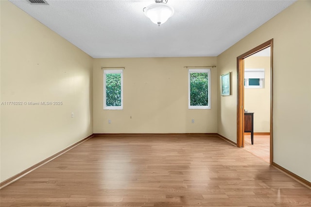 11472 SW 28th Ter, Miami, FL 33165 - spare room featuring light wood finished floors and a textured ceiling