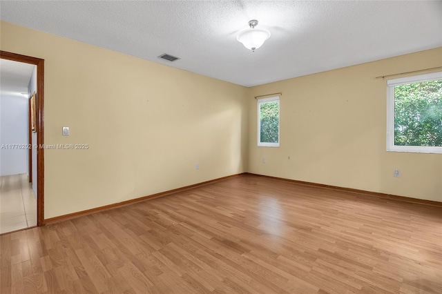 11472 SW 28th Ter, Miami, FL 33165 - spare room featuring light wood finished floors and a textured ceiling