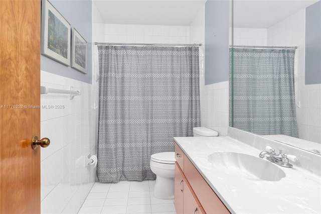 11472 SW 28th Ter, Miami, FL 33165 - full bathroom with tile walls, tile patterned floors, toilet, vanity, and a wainscoted wall