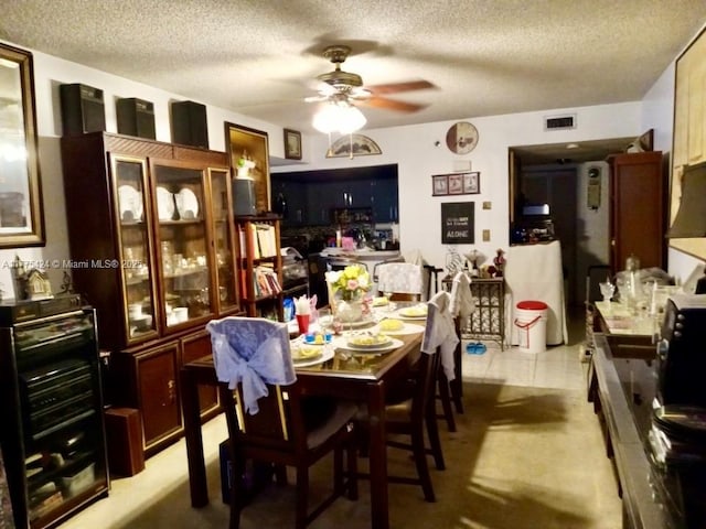 dining area with visible vents, ceiling fan, and a textured ceiling