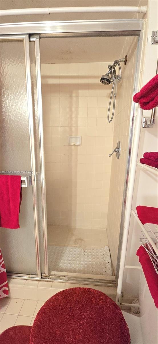 full bath featuring tile patterned flooring and a stall shower