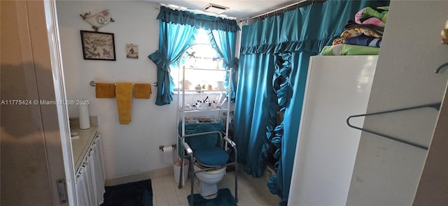 bathroom with tile patterned floors, visible vents, and toilet