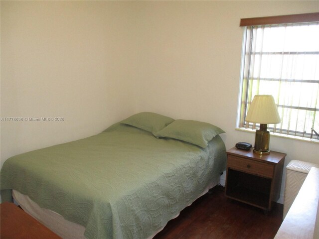 105 NW 32nd Pl, Miami, FL 33125 - bedroom featuring wood finished floors and multiple windows