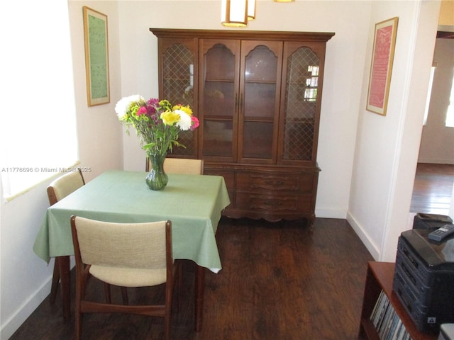 105 NW 32nd Pl, Miami, FL 33125 - dining area featuring baseboards and dark wood-type flooring